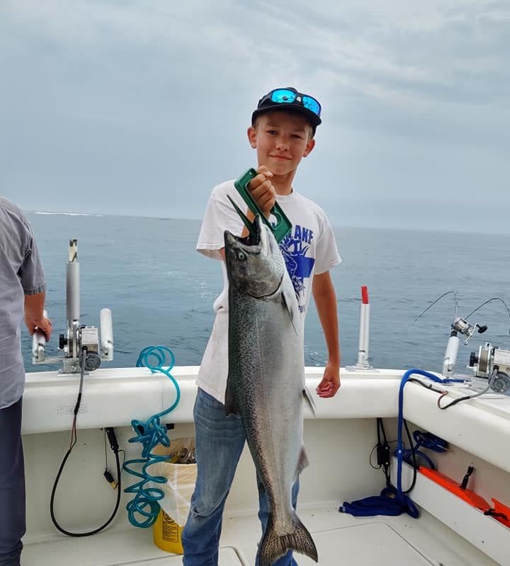 child caught large fish lake michigan