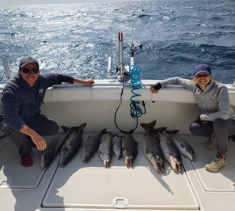 man and woman lake michigan fishing catch